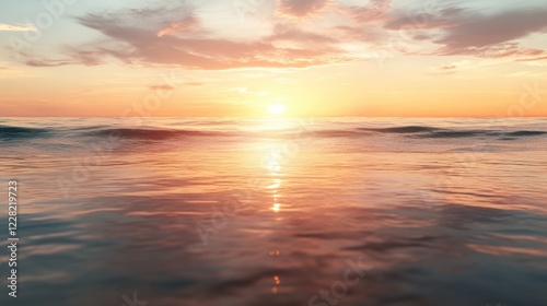 Warm golden-hour sunset over the ocean, soft clouds reflecting pink and orange hues