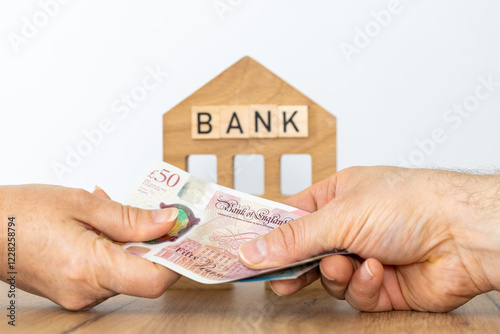 Great Britain money. Bank loan in British Pound. Finance business concept. Bank symbol, handing cash to customer. Money transfer, Financial operations. close up