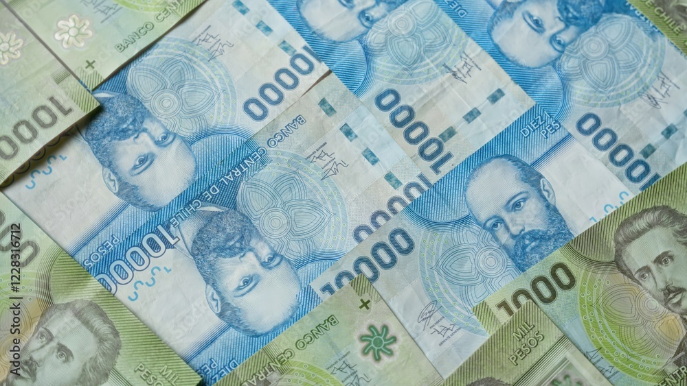 Obraz premium Chilean banknotes of various denominations are spread out, showcasing the colorful currency and intricate designs, representing the financial landscape of chile vividly.