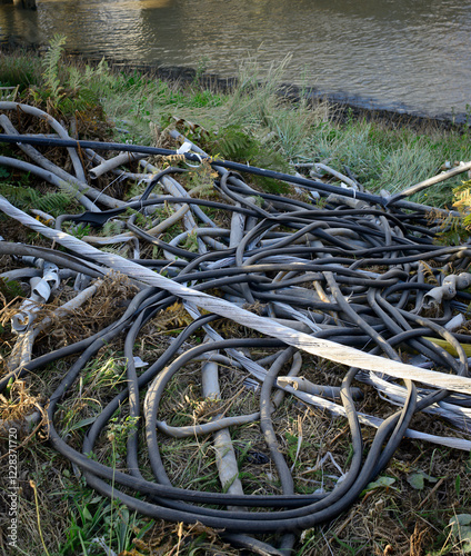 Cable and sheathing abandoned next to the Thames, Dartford, UK photo