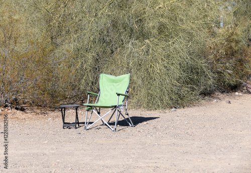 Camping Chair and Table sitting alone in the desert sand