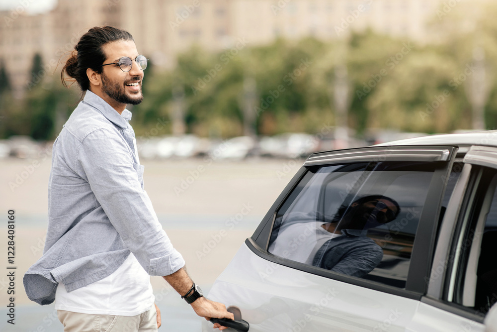 Cheerful middle-eastern young man in casual getting in taxi, open auto back door, taking cab home or to business meeting, looking at copy space. Car service, transportation, taxi concept Cheerful middle-eastern young man in casual getting in taxi, open auto back door, taking cab home or to business meeting, looking at copy space. Car service, transportation, taxi concept