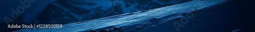 a photograph of a steep snowy mountain slope blue hour switzerland with the materhorn in the background 2d view photo