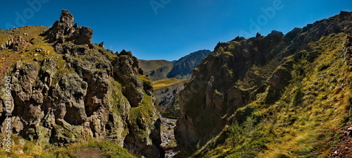 Russia, Elbrus region. The differences of the Kyzylkol mountain river with picturesque valleys and waterfalls at the foot of the highest mountain in the Caucasus - Elbrus (5642 m). photo