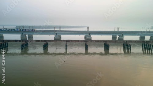 train going from naigoan to bhayandar on vasai creek bridge side closeup drone view photo