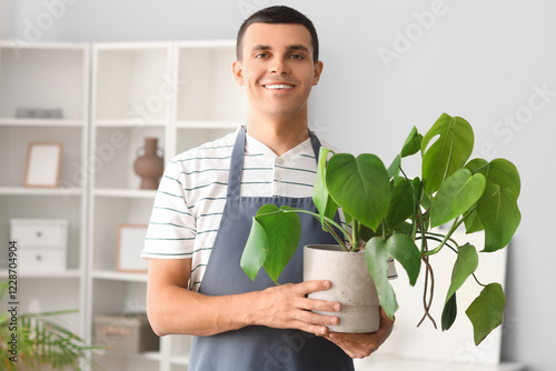 Male gardener with plant at...