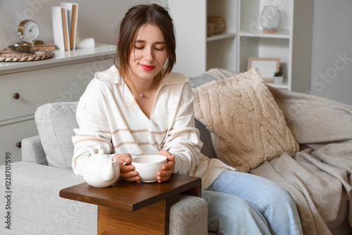 Young woman with cup of hot...
