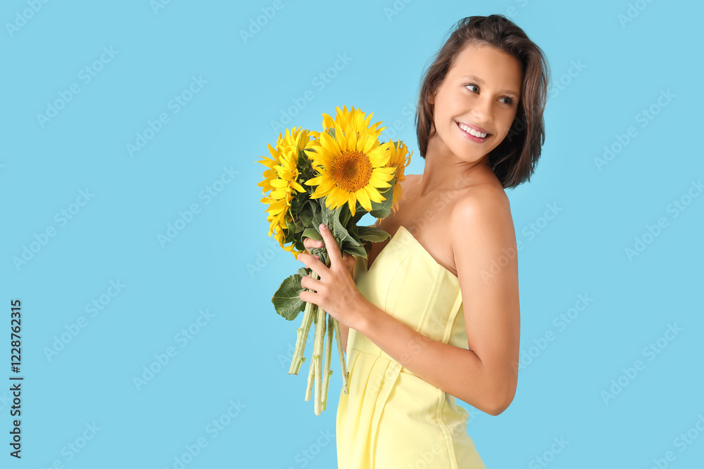 Beautiful young happy woman with bouquet of sunflowers on blue background Beautiful young happy woman with bouquet of sunflowers on blue background