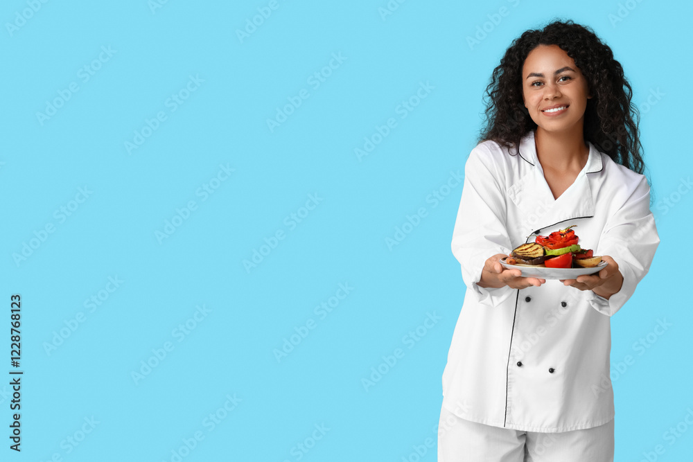 Beautiful young happy African-American female chef with plate of tasty grilled vegetables on blue background Beautiful young happy African-American female chef with plate of tasty grilled vegetables on blue background