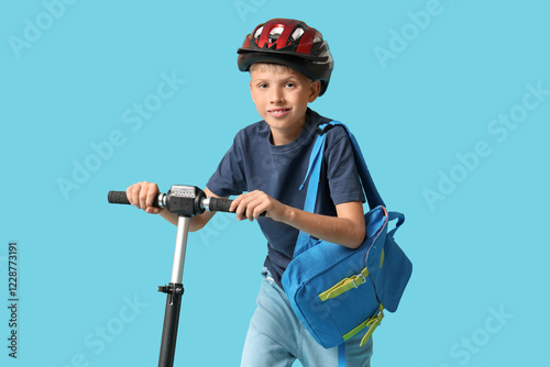 Cute schoolboy in helmet wi...