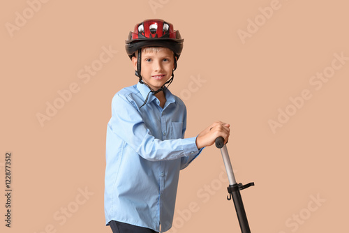 Cute schoolboy in helmet wi...
