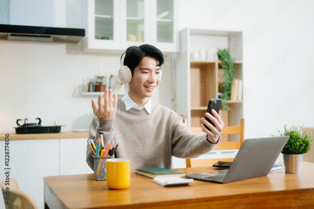 Young man using laptop while sitting at home. Young woman sitting in kitchen and working Young man using laptop while sitting at home. Young woman sitting in kitchen and working