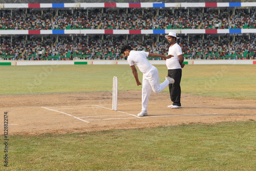 The bowler takes his position and marks out his run-up during the cricket game