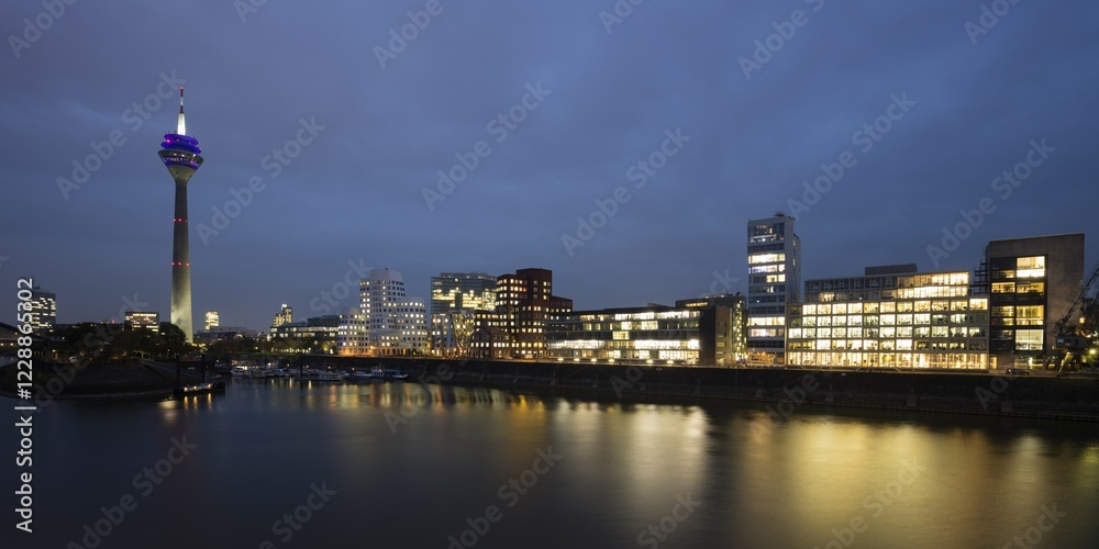 Fototapeta premium Rhine Tower and Gehri Buildings, Dusk, Media Harbour, Düsseldorf, Rhineland, North Rhine-Westphalia, Germany, Europe