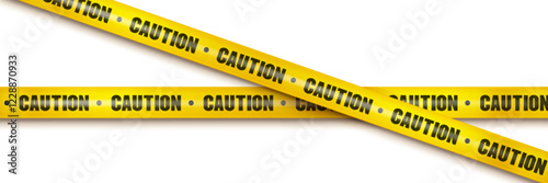 Yellow caution barrier tape with black text crossed over white background - warning stripe pattern repeated on plastic ribbon. Safety and hazard notification element for restricted area marking.