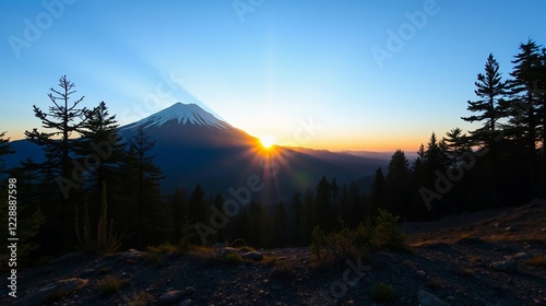 Majestic Sunrise Over Mount Hood with Radiant Sunbeams Piercing Through Clear Blue Sky