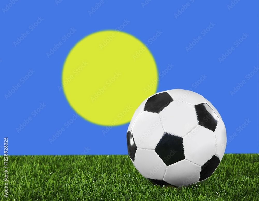 Fototapeta premium The Palau flag and soccer ball on the green grass