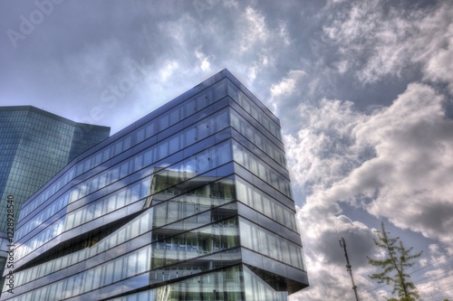 Modern building with glass facade in front of a cloudy sky and reflecting light, Prime Tower Zurich, HDR artistic, Zurich, Canton of Zurich, Switzerland, Europe photo