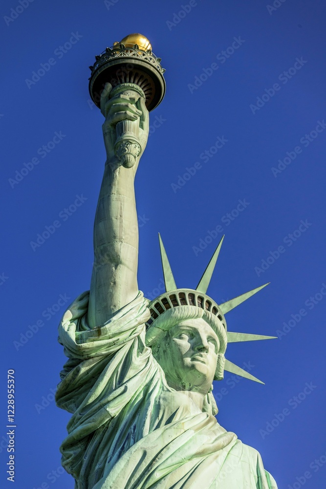 Fototapeta premium Statue of Liberty in front of blue sky, Liberty Island, Statue of Liberty National Monument, New York City, New York, USA, North America