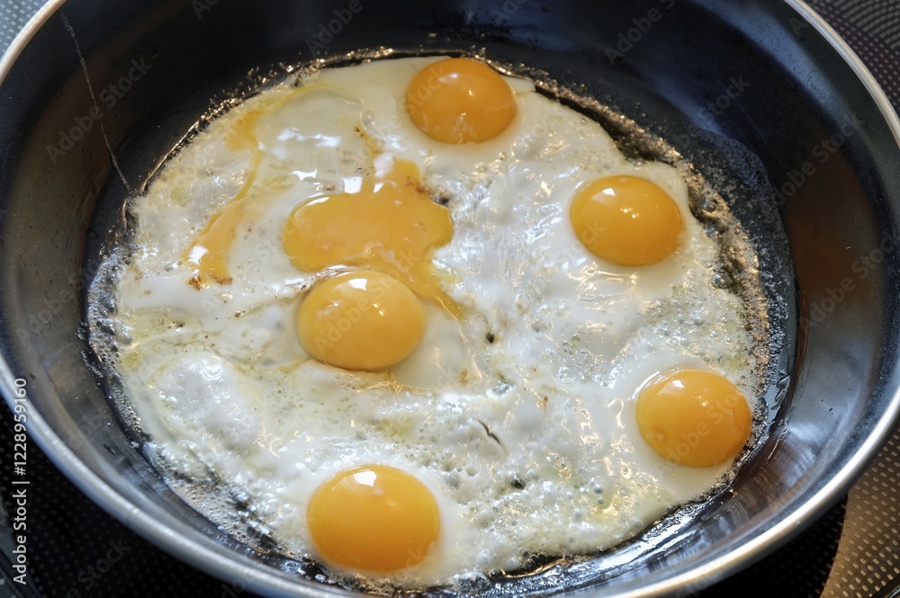 Quail eggs being fried in a pan Quail eggs being fried in a pan