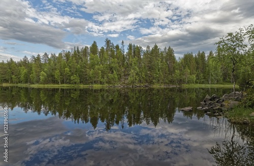 Mixed forest reflection in lake, Juuma, Finland, Europe photo