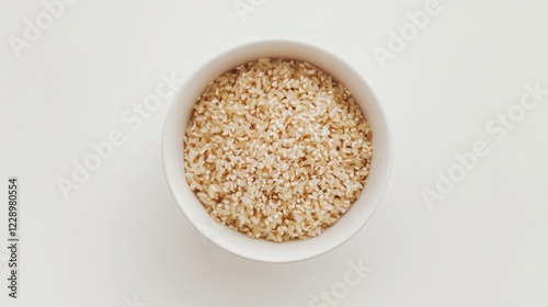 A minimalist bowl of plain brown rice with a light sprinkle of sesame seeds, served in a simple white ceramic bowl, Brown rice centered photo