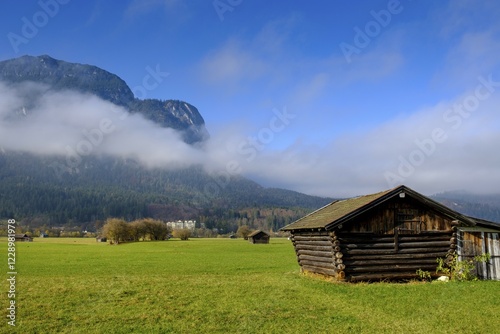 Hay barn, green meadow with fog, behind Wetterstein range, Zugspitze, mountain landscape, Garmisch-Partenkirchen, Upper Bavaria, Bavaria, Germany, Europe photo