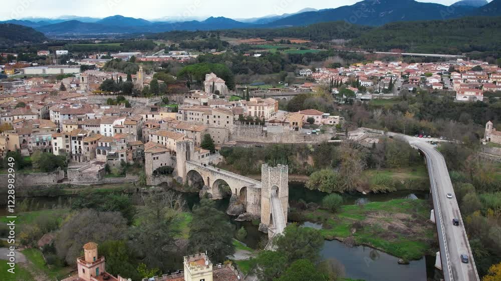 Besalu city with downtown, bridge and city center, and mountains on the back in Catalonia, Spain. High quality 4k aerial view drone footage Besalu city with downtown, bridge and city center, and mountains on the back in Catalonia, Spain. High quality 4k aerial view drone footage