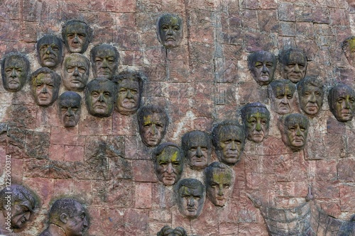 Close-up of faces from communist era on façade of city market, Kutaisi, Imereti Region, Georgia, Asia