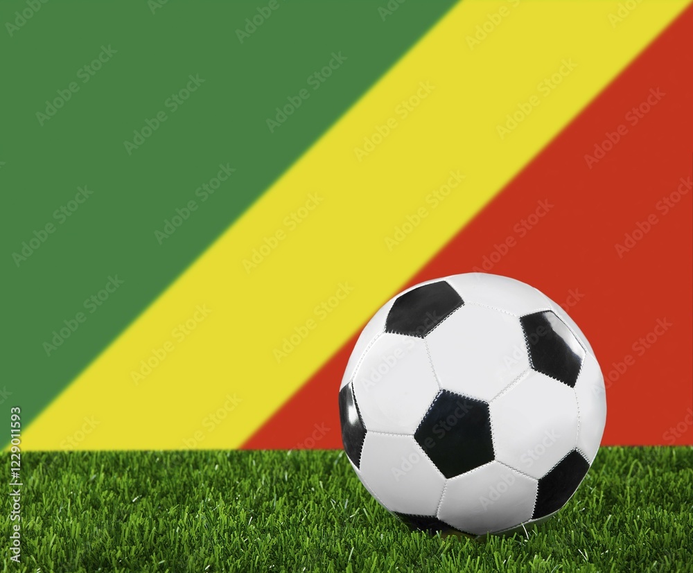 The Congo flag and soccer ball on the green grass