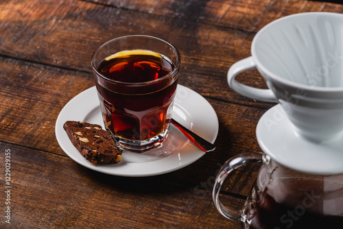 A cup of coffee and third generation pour over coffee brewing equipment on stone floor photo