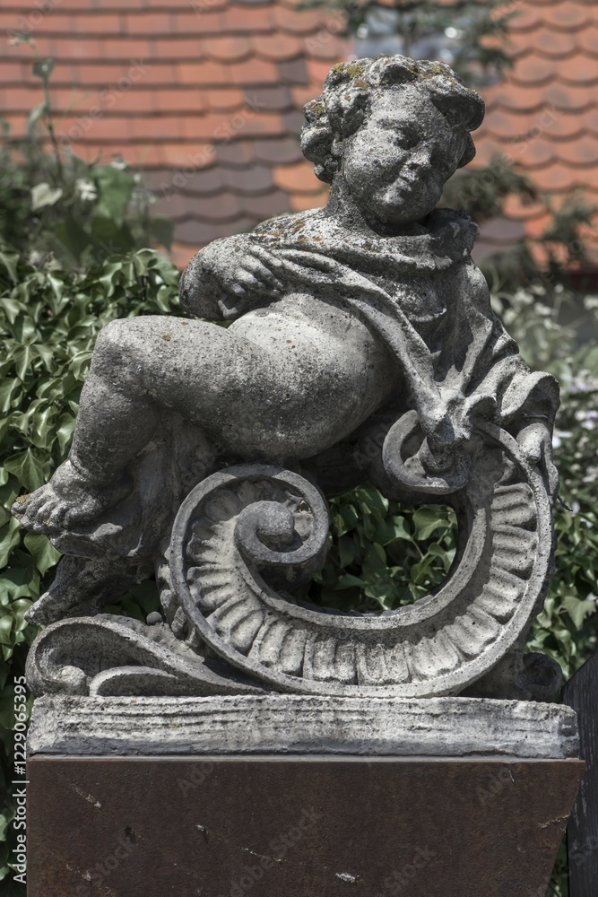 Fototapeta premium Putti figure on a wall, Nördlingen, Bavaria, Germany, Europe