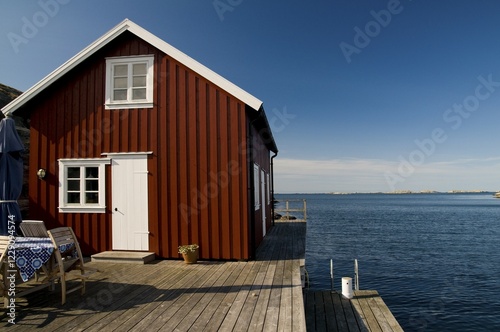 Red wooden house on the sea, Bohuslaaen, Sweden, Europe photo