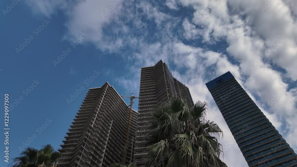 Skyscraper buildings against background of blue sky with clouds. Skyscraper buildings against background of blue sky with clouds.