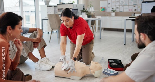 Mannequin, first aid and workshop with people and defibrillator for teaching, cardiac arrest or safety protocol. Healthcare, medical simulation and heart rhythm rescue with paramedic course in office