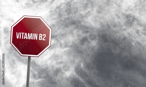 Vitamin B2, red sign with clouds in background photo