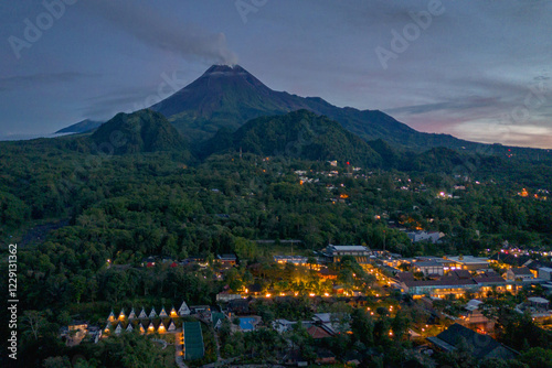 Morning shot of Mount Merapi glowing amidst the greenery, with Kaliurang village nestled at its base photo