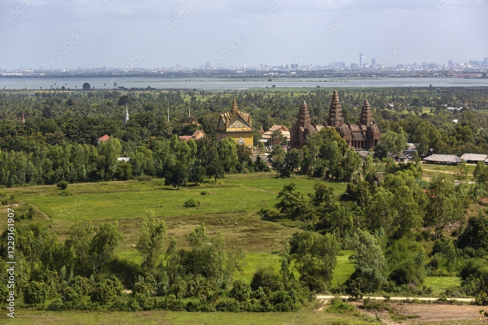 Fototapeta premium Towers of Prasat Phnom Reap temple, rear skyline of Phnom Penh, Cambodia, Asia