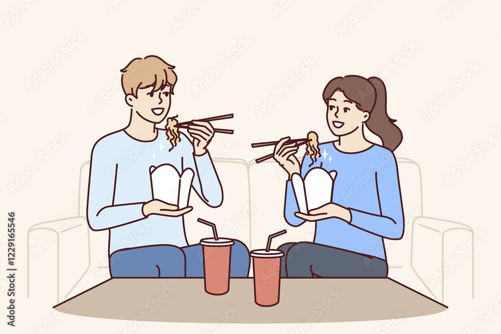 Couple eat boxed wok noodles sitting on couch using chopsticks delivered from chinese restaurant. Man and woman are eating asian fast food and enjoying taste of wok bought in takeaway cafe Couple eat boxed wok noodles sitting on couch using chopsticks delivered from chinese restaurant. Man and woman are eating asian fast food and enjoying taste of wok bought in takeaway cafe
