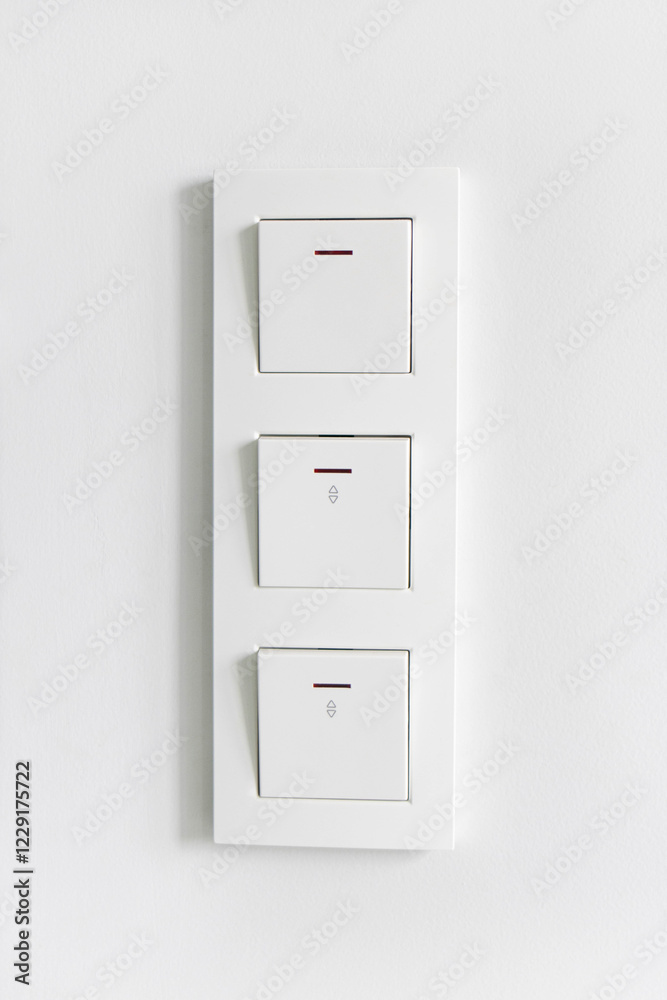 A close-up of a white Electric block with light switches is isolated on a white background A close-up of a white Electric block with light switches is isolated on a white background