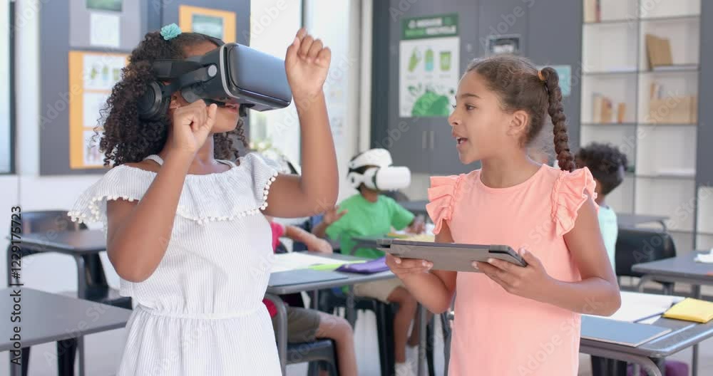 Biracial girls explore virtual reality in a school classroom