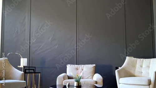Create a minimalist video where each element of the room is introduced piece by piece. Start with the dark classic wall as the backdrop.