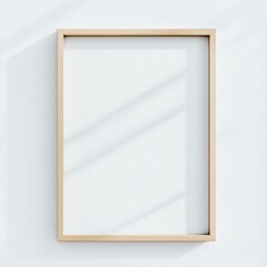minimalist light wood picture frame mockup against blank white wall with soft natural lighting, perfect for artwork, photography, or digital designs display
