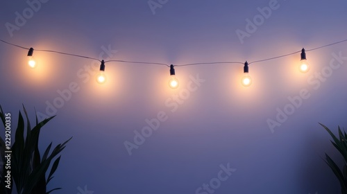 Soft, warm vintage string lights illuminate a blue wall, creating a cozy atmosphere. This decorative setup is perfect for enhancing home interiors and events.