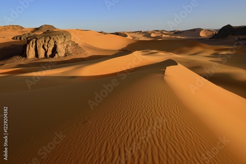 Sanddunes and rock towers at Moul Naga, Tadrart, Tassili n'Ajjer National Park, Sahara desert, Algeria, Africa photo