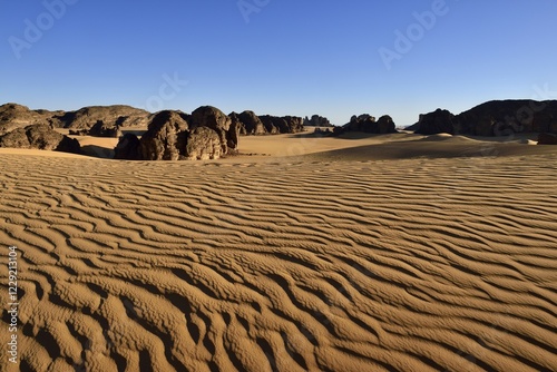 Sanddunes and rock towers in Tassili n´ Ajjer National Park, Sahara desert, Algeria, Africa photo