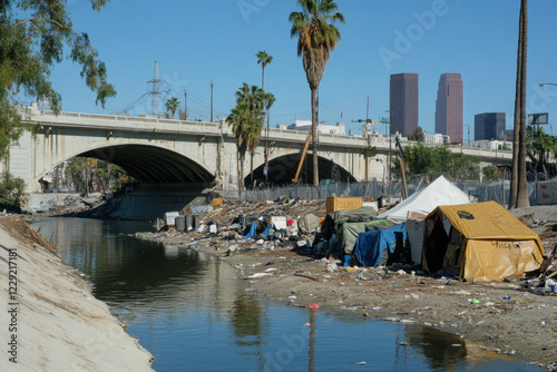 Homeless encampment under a bridge, highlighting rising poverty