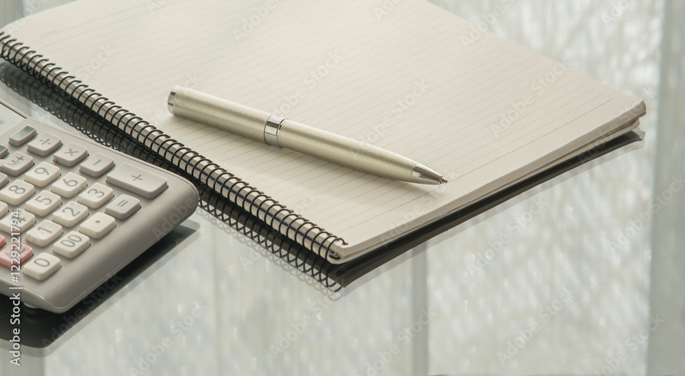 notebook, calculator and pen on the desk. notebook, calculator and pen on the desk.