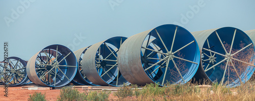 Steel Large  diameter pipes are stacked in an industrial factory at construction site. Large diameter pipes in an industrial factory. Large concrete pipes waiting for infrastructure work.