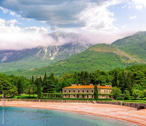 awesome landscape of sea gulf with beautiful turquoise water with amazing green forest shore wwith pakr and hotel and nice green mountains on background photo